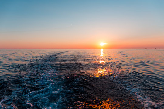Fototapeta Sea sunset with ship trace
