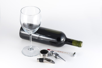 Obraz premium Red wine bottle and accessories