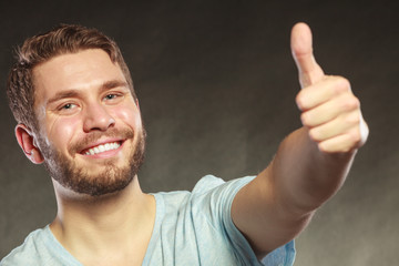 Handsome man guy giving thumb up gesture.