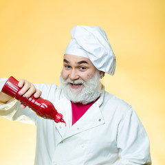 Bearded cook with ketchup bottle