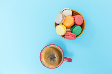 Cup of coffee with milk and macarons on white background. Flat l