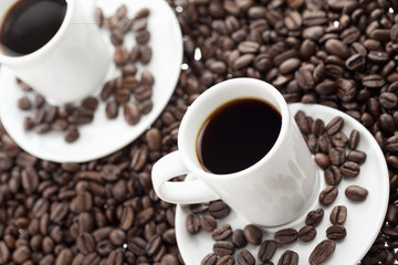 close-up image of two black coffee cups.