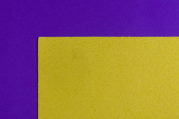 Eva foam ethylene vinyl acetate sponge plush lemon yellow surface on purple smooth background