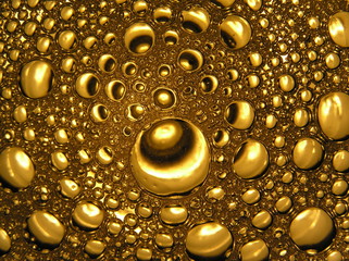 golden bubbles in beer abstract light close up, drops of water
