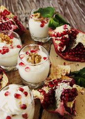 yogurt dessert with walnuts and pomegranate selective focus