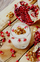 yogurt dessert with walnuts and pomegranate selective focus