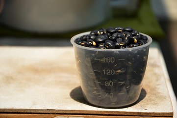 Fototapeta na wymiar Black beans in measuring cup
