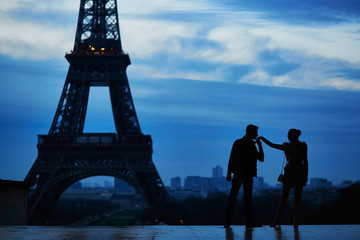 Silhouettes of romantic couple near the Eiffel tower