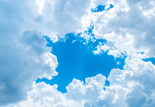 Big white cloud and light ray behind cloud with blue sky