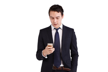 Young Caucasian business man looking at mobile phone smiling