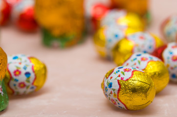 Easter chocolate little eggs andchicks covered in multicolor paper