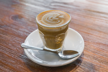 Cup of hot coffee with latte art, selective focus on latte art