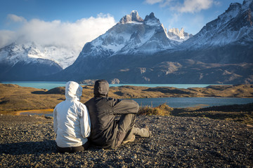 Young couple enjoying the a beautiful scenario in Torres del Paine National Park, Patagonia, Chile