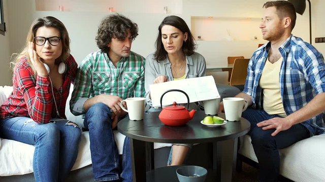 Friends looking on the map and drinking tea
