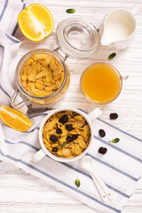 Breakfast concept with corn flakes, milk and orange juice