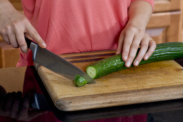 a chef slicing bitter gourd