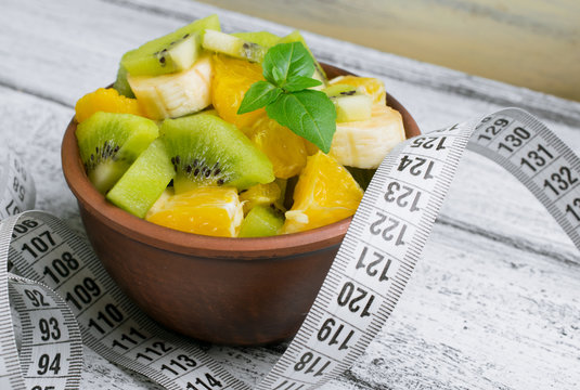 Fruit salad with kiwi, banana and orange for slimming and centim
