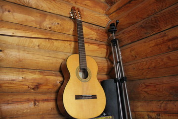 Fototapeta premium Acoustic guitar on the background of wood