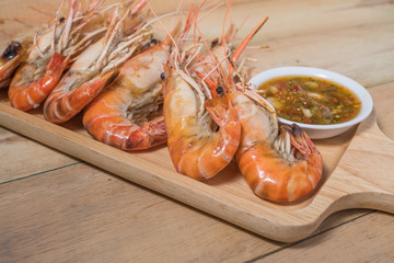 Fresh and grilled of Tiger prawns on wood plate