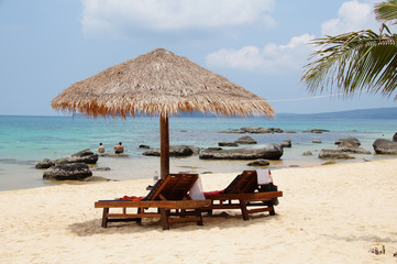 Two chairs and umbrella on tropical island, Cambodia

