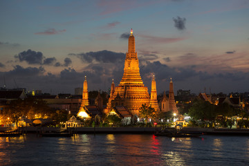 Naklejka premium River and Wat Arun Temple at night in Bangkok Thailand