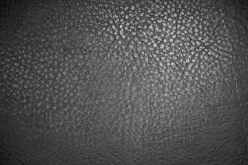 Black leather material texture background close up
