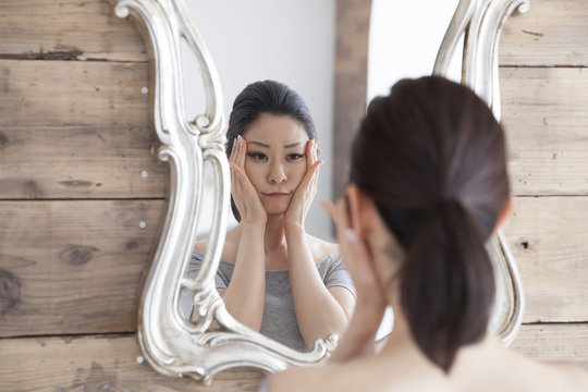 Women are thinking while looking in the mirror