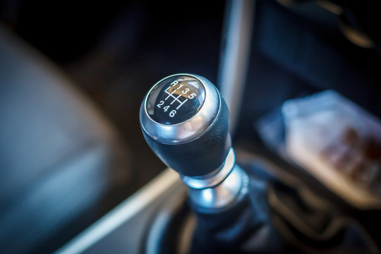 Six speed gear shift in car, Gear transmission, hand using a car gear, detail of modern car interior, gear stick, transmission in expensive car.