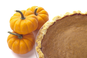 cropped close-up shot of pumpkins and pumpkin pie.