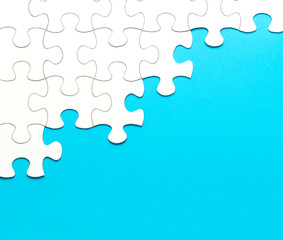 White jigsaw puzzle on blue background