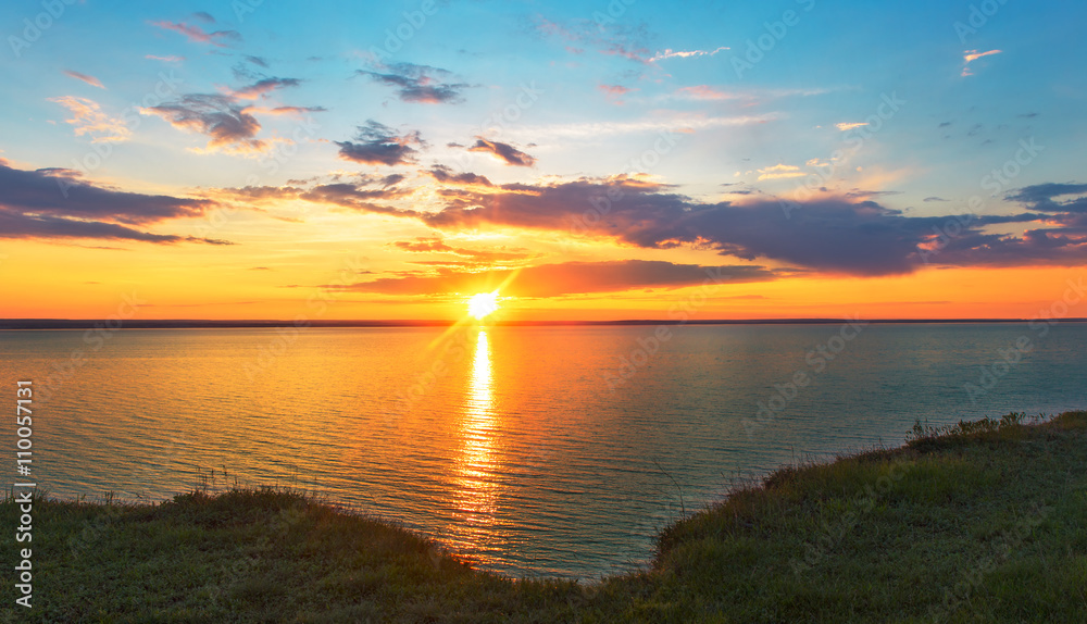 Wall mural orange sunset over the sea.