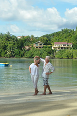 Fototapeta na wymiar elderly couple rest at tropical resort