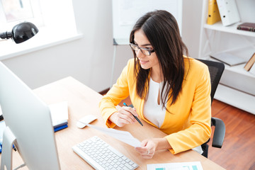 Happy businesswoman holding paper