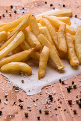 fries on a wooden table with seasoning
