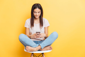 Woman sitting on the chair and using smartphone