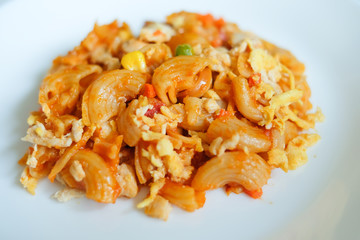 macaroni pasta in tomato sauce on a wooden table