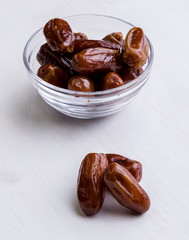dried dates on white table