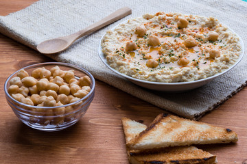home made hummus on wooden table