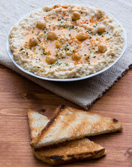 home made hummus on wooden table