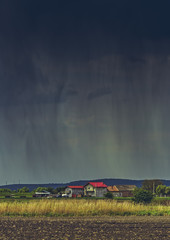 Heavy torrential rain pouring down a village in Transylvania region, Romania.