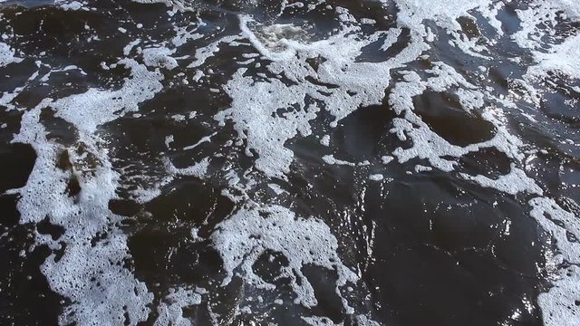 fast flowing river with foam and waves