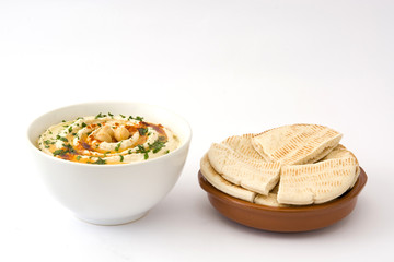 Hummus in bowl with pita bread isolated on white background