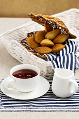 Breakfast. French pastries madeleines with cup of tea.