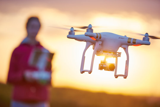 drone quadcopter flying at sunset