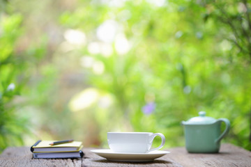 vintage  teapot  with cup and notebooks  