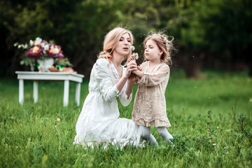 Naklejka premium A mother and child playing and having fun in nature. The concept of life values and happiness