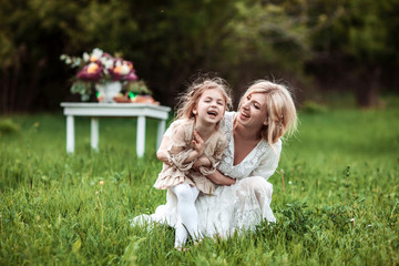 A mother and child cuddling and having fun in nature. The concept of life values and happiness
