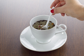 woman stirring lemon tea.