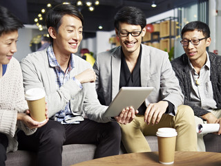 young asian business people using tablet in office