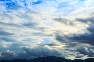 Fototapeta premium Mountain range with blue sky and heavy clouds.
